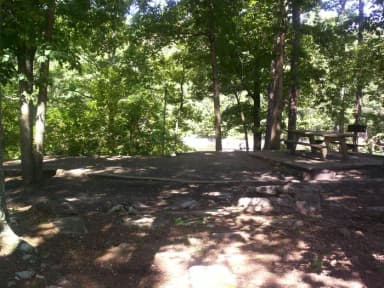 Flat dirt site, picnic table.