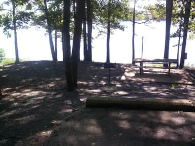 Paved slot, picnic table, water view.