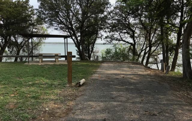 RV site with covered picnic table and Waco Lake in the background