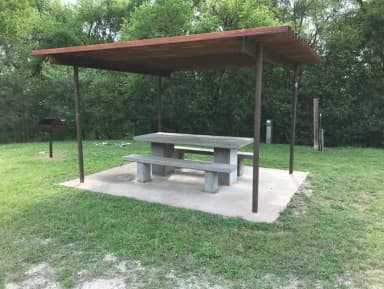 RV site with covered picnic table and grill