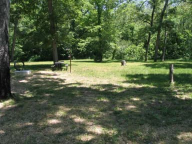 Campsite 13 showing picnic table, lantern post and fire ring.