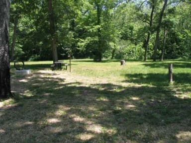 Campsite 13 showing picnic table, lantern post and fire ring.