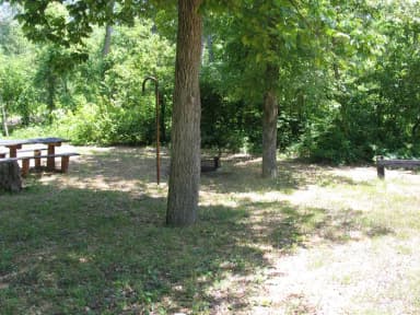 Campsite 22 showing picnic table, lantern post and fire ring.