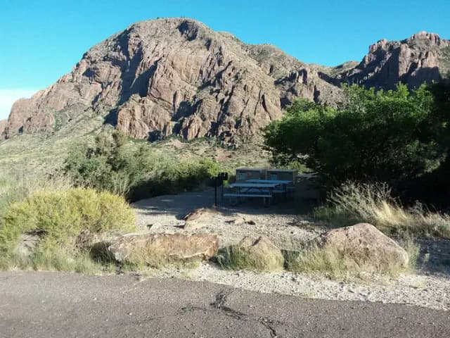 Group Site L with picnic tables and bear boxes at site with mountains in the background