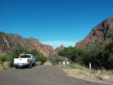 Parking spaces overlooking the campsite with mountains in the background