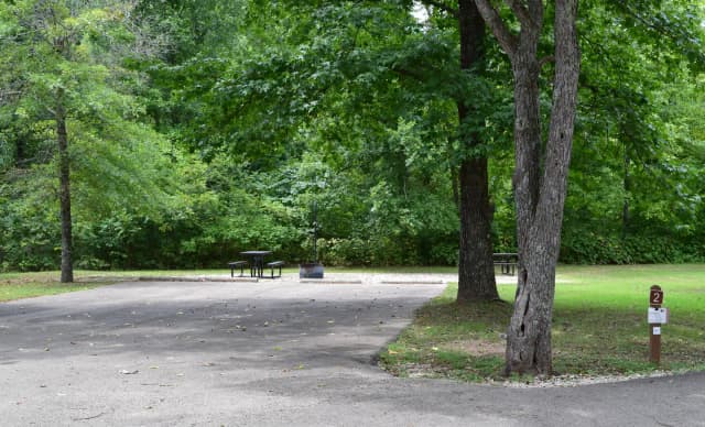 Campsite 2 showing double wide parking spur, picnic tables, lantern post and fire ring