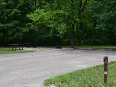 Campsite 3 show double wide parking spur, picnic tables, lantern post and fire ring