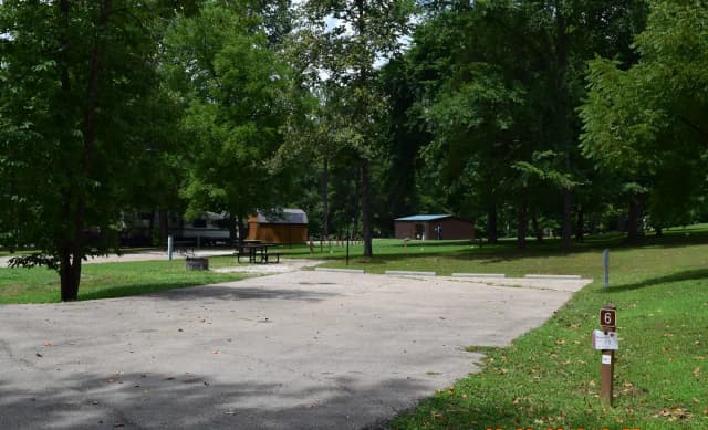 Double Campsite 6 showing double wide parking, picnic tables, lantern post and fire ring