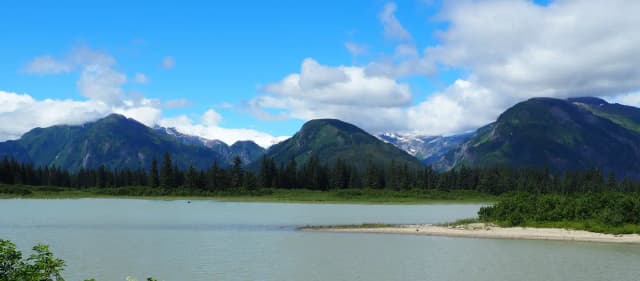 View from Shakes Slough 1 Cabin showing snow capped mountains and water