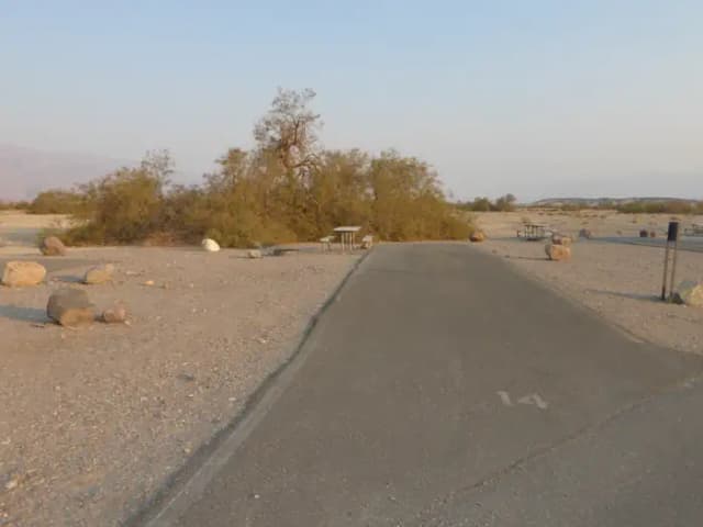 Furnace Creek Campground Standard Non-electric Site #14 with picnic table, fire ring, and paved parking pad.