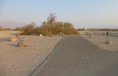 Furnace Creek Campground Standard Non-electric Site #14 with picnic table, fire ring, and paved parking pad.