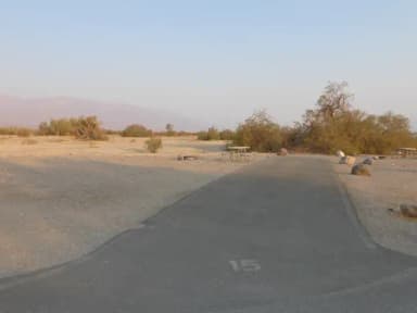 Furnace Creek Campground Standard Non-electric Site #15 with picnic table, fire ring, and paved parking pad.