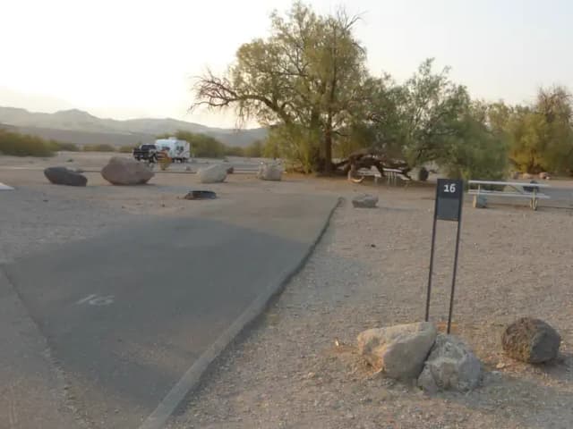 Furnace Creek Campground Standard Non-electric Site #16 with picnic table, fire ring, and paved parking pad.