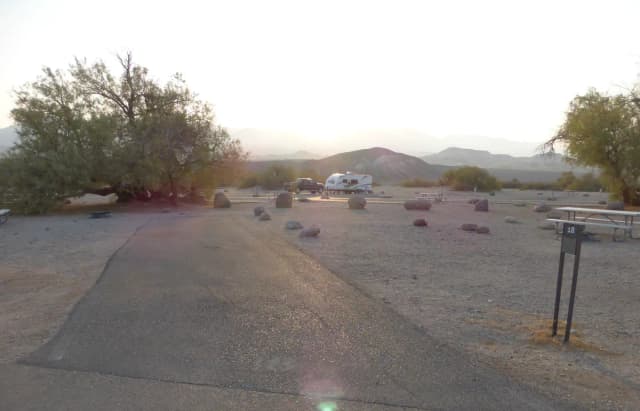 Furnace Creek Campground standard nonelectric site #18 with picnic table and fire ring.