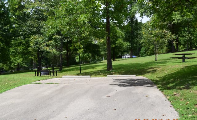 Campsite 12 showing wide parking spur, picnic tables, lantern post and fire ring