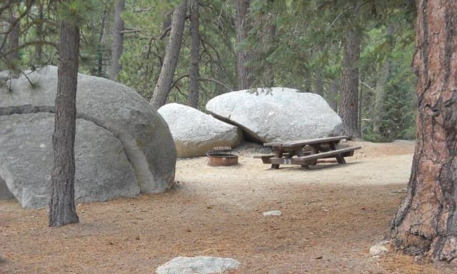 Boulder Basin campsite 23 with picnic table and fire pit.