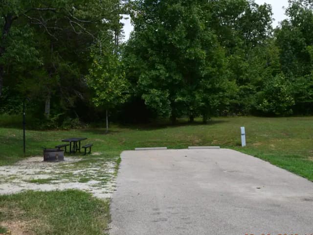 Campsite 23 showing double parking, picnic table, lantern post, electric hookup and fire ring