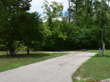 Campsite 24 showing parking spur, picnic table, electric hookup and fire ring