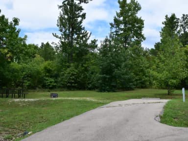 Campsite 26 showing parking spur, pinic table, electric hookup and fire ring