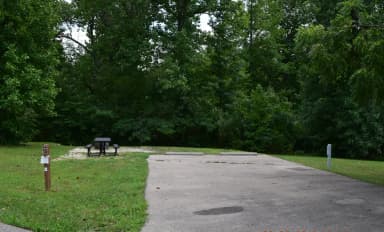 Campsite 27 showing parking spur, picnic table, lantern post, electric hookup and fire ring.