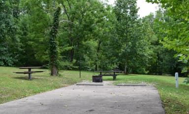 Campsite 28 showing parking spur, picnic tables, lantern post, electric hookup and fire ring