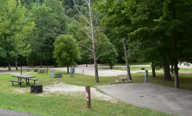 Campsite 32 showing parking spur, picnic table, electric hookup and fire ring