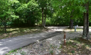 Campsite 33 showing parking spur, picnic table, electric hookup and fire ring