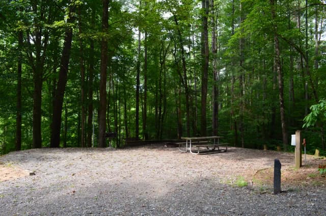 Gravel site with fire pit, table, grill