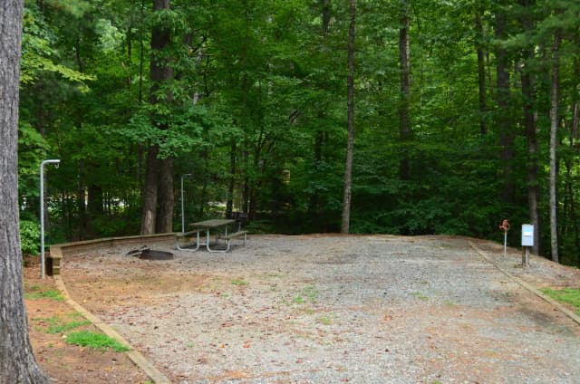 Gravel site with fire pit, table, grill