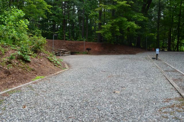 Gravel site with fire pit, table, grill