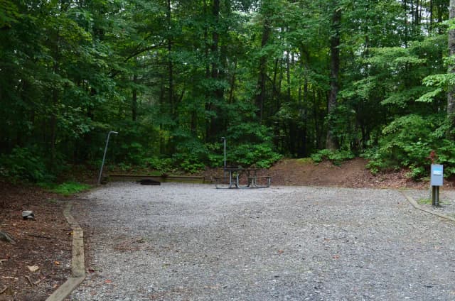 Gravel site with fire pit, table, grill