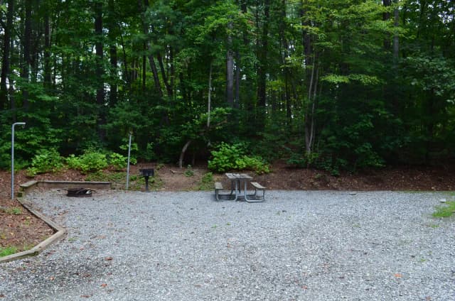 Gravel site with fire pit, table, grill