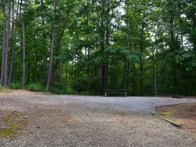 Gravel site with fire pit, grill, table