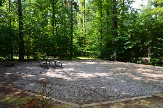 Gravel site with fire pit, grill, table