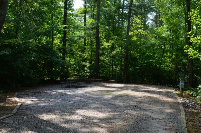 Gravel site with fire pit, grill, table