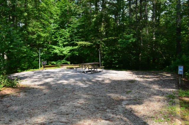 Gravel site with fire pit, grill, table