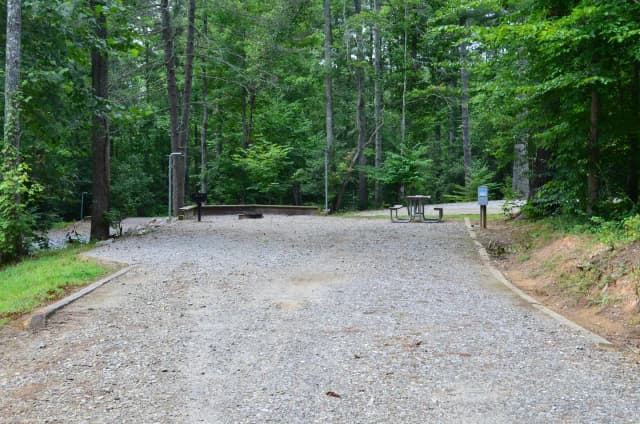 Gravel site with fire pit, grill, table