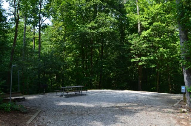 Gravel site with fire pit, grill, table