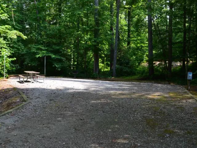 Gravel site with fire pit, grill, table