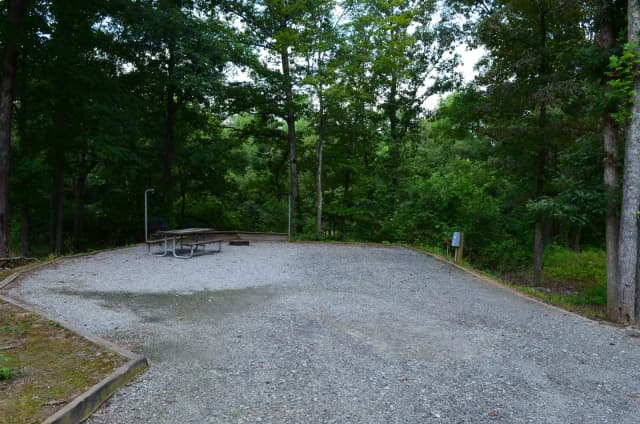 Gravel site with fire pit, table, grill