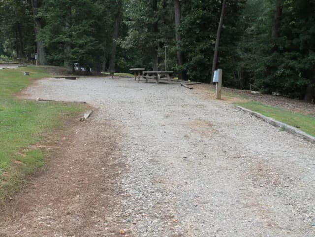 Long gravel pull in site fire pit, table, grill