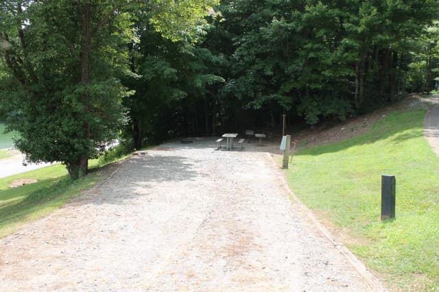 Long gravel pull in and site with table, fire pit, grill