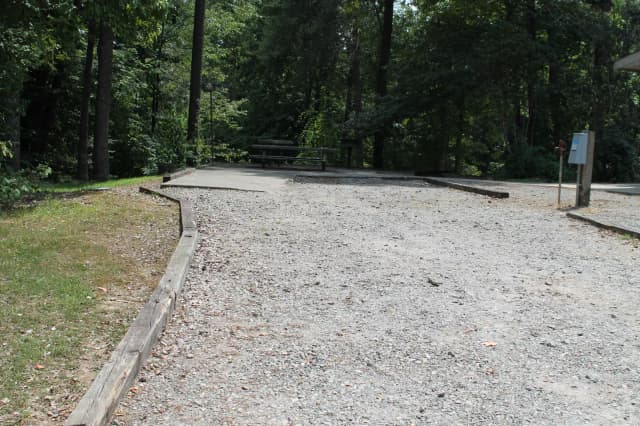 Gravel site with table, fire pit, grill