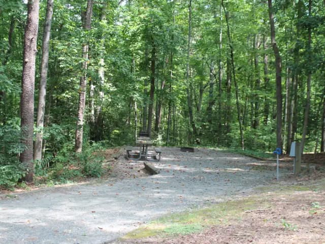 Gravel site with table, fire pit, grill