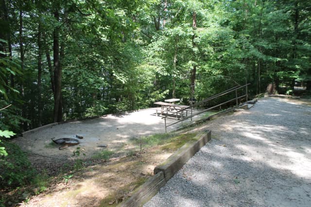 Gravel site with fire pit, table, grill