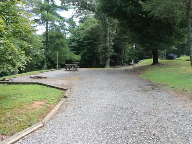 Long gravel pull in site fire pit, table, grill