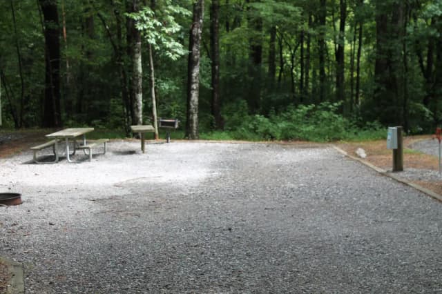 Gravel site with fire pit, table, grill