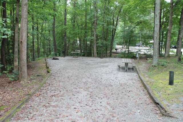 Gravel site with fire pit, table, grill