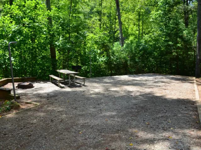 Gravel site with fire pit, table, grill