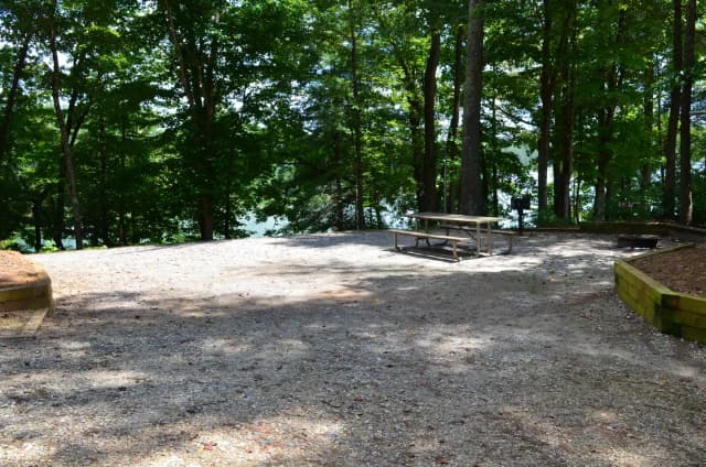 Gravel site with fire pit, table, grill